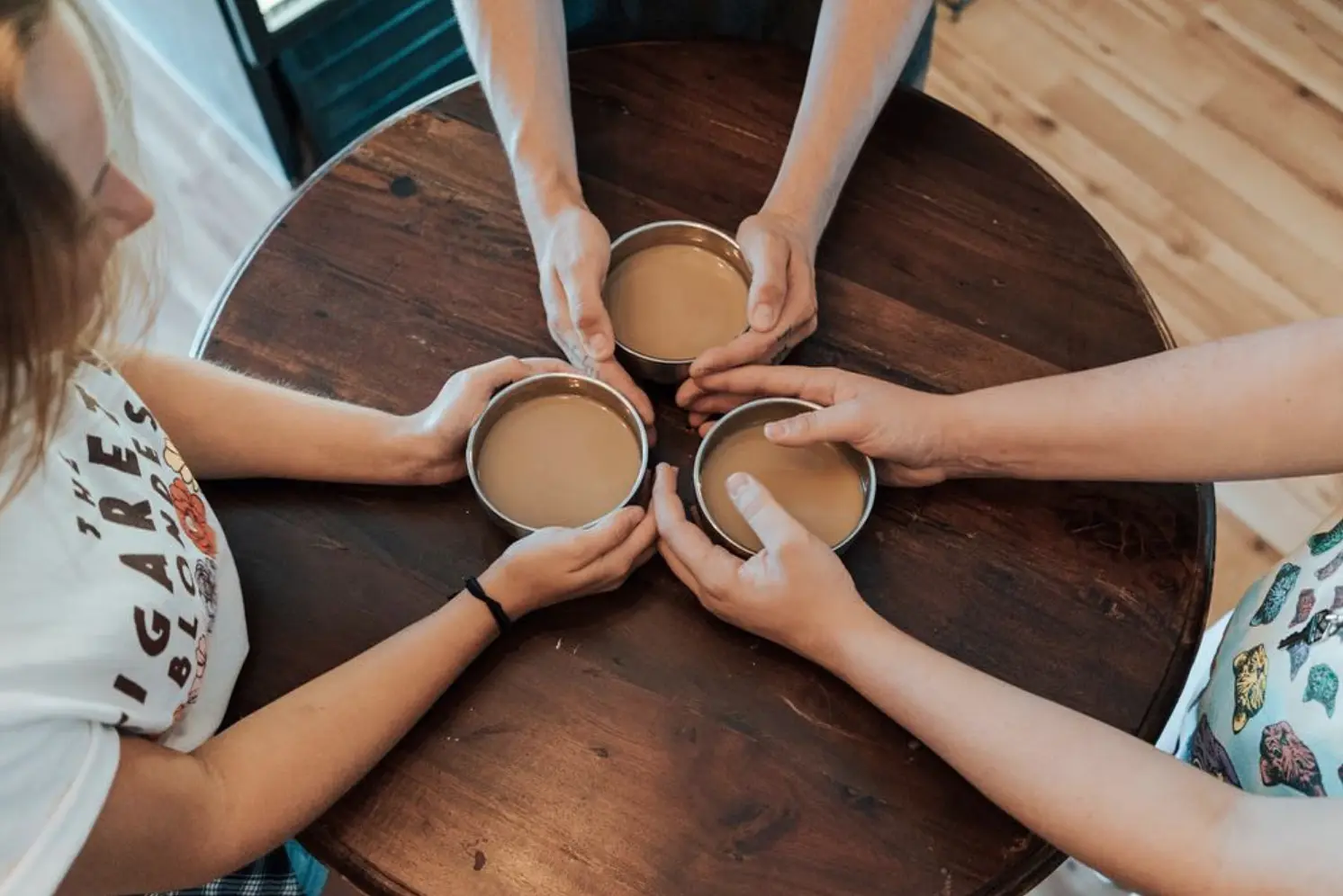 Friends toasting with espresso cups